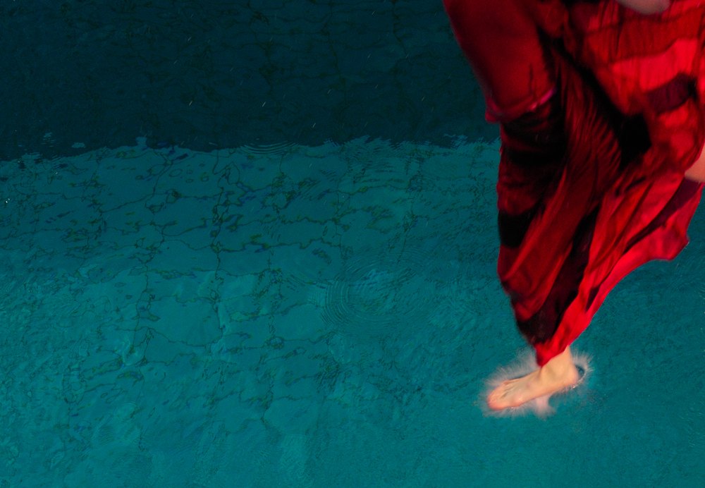 After Conversation: a later water work, a foot in red touching the surface of a pool